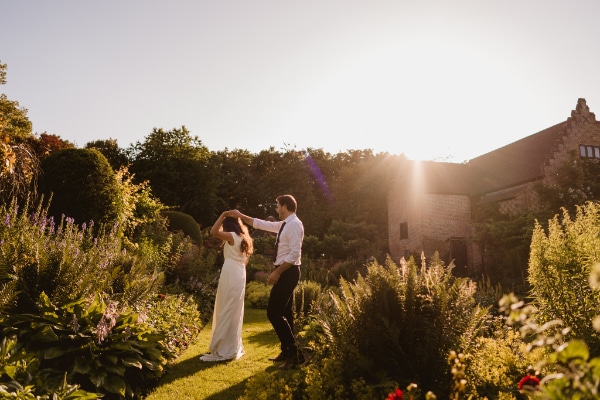 Chenies Manor House bride & groom dancing in garden