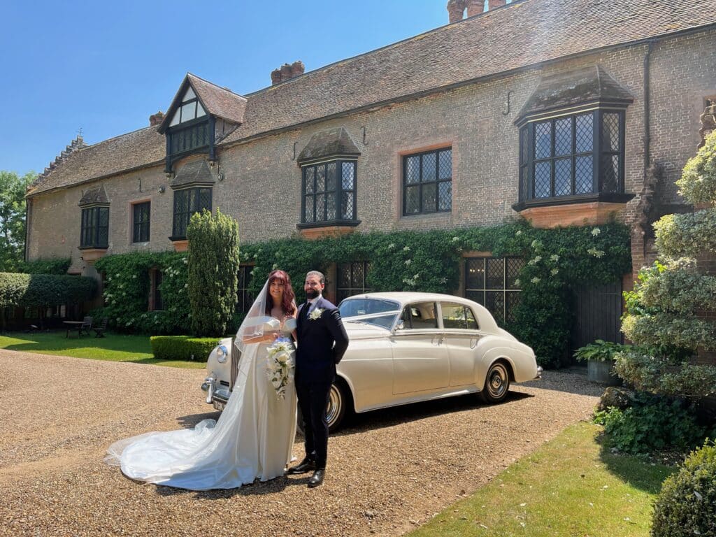 Chenies Manor House bride and groom with wedding car