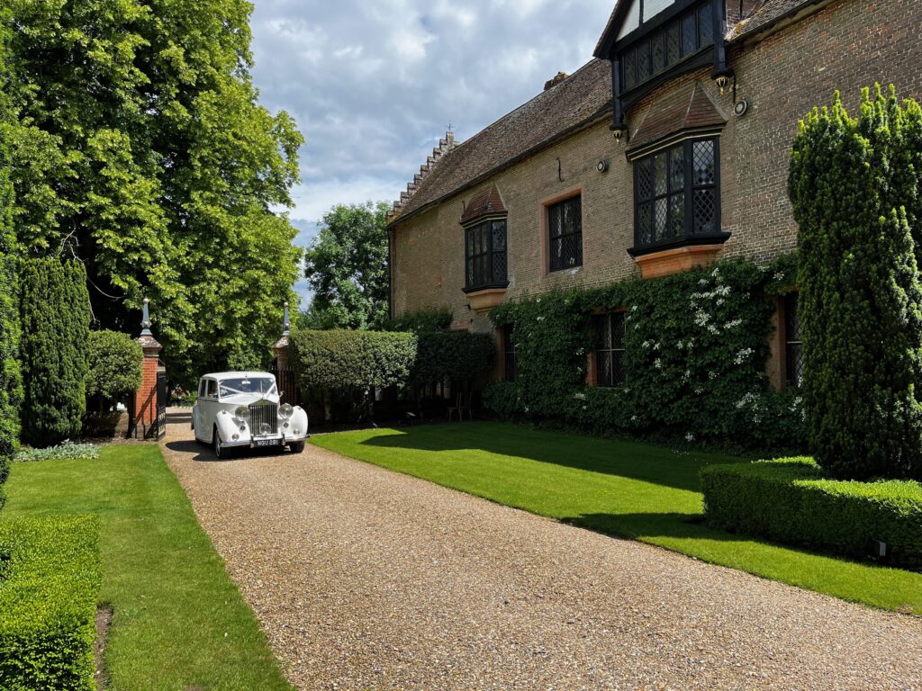 Classic car approaching Chenies Manor House